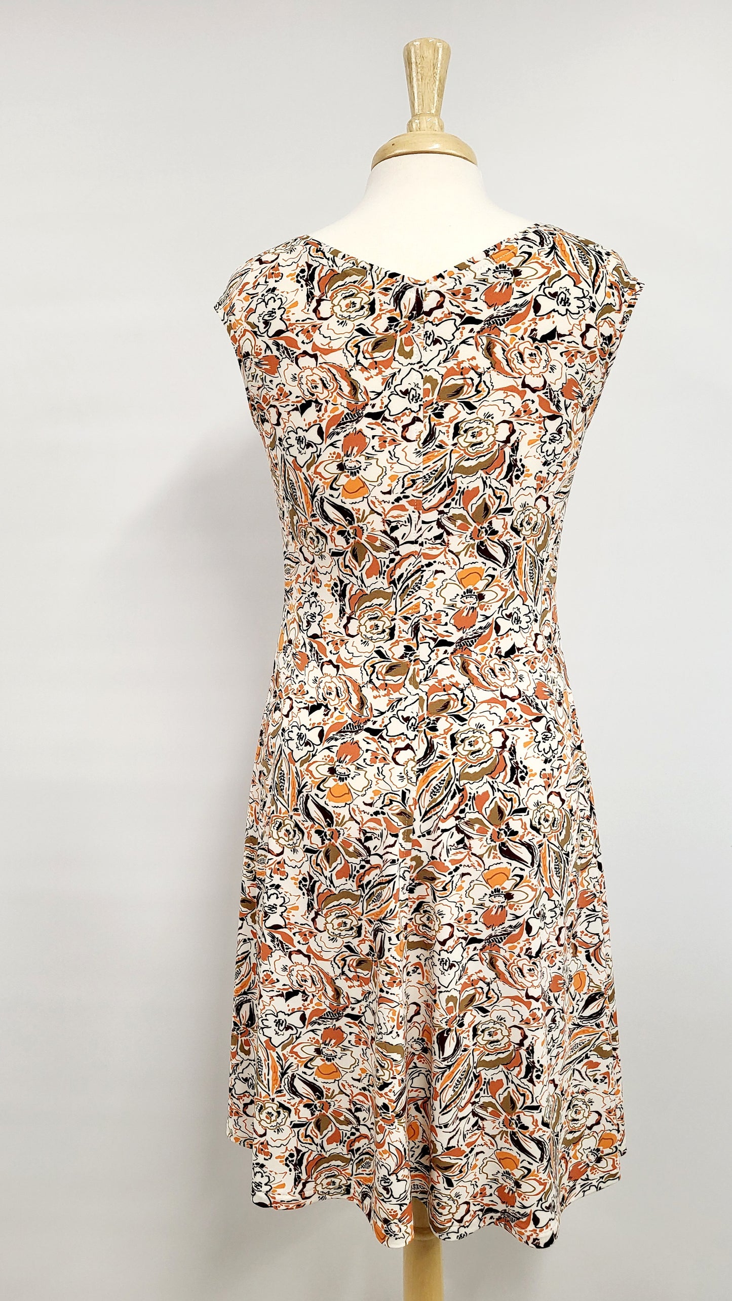 "Alice" dress printed in warm colors on a white background