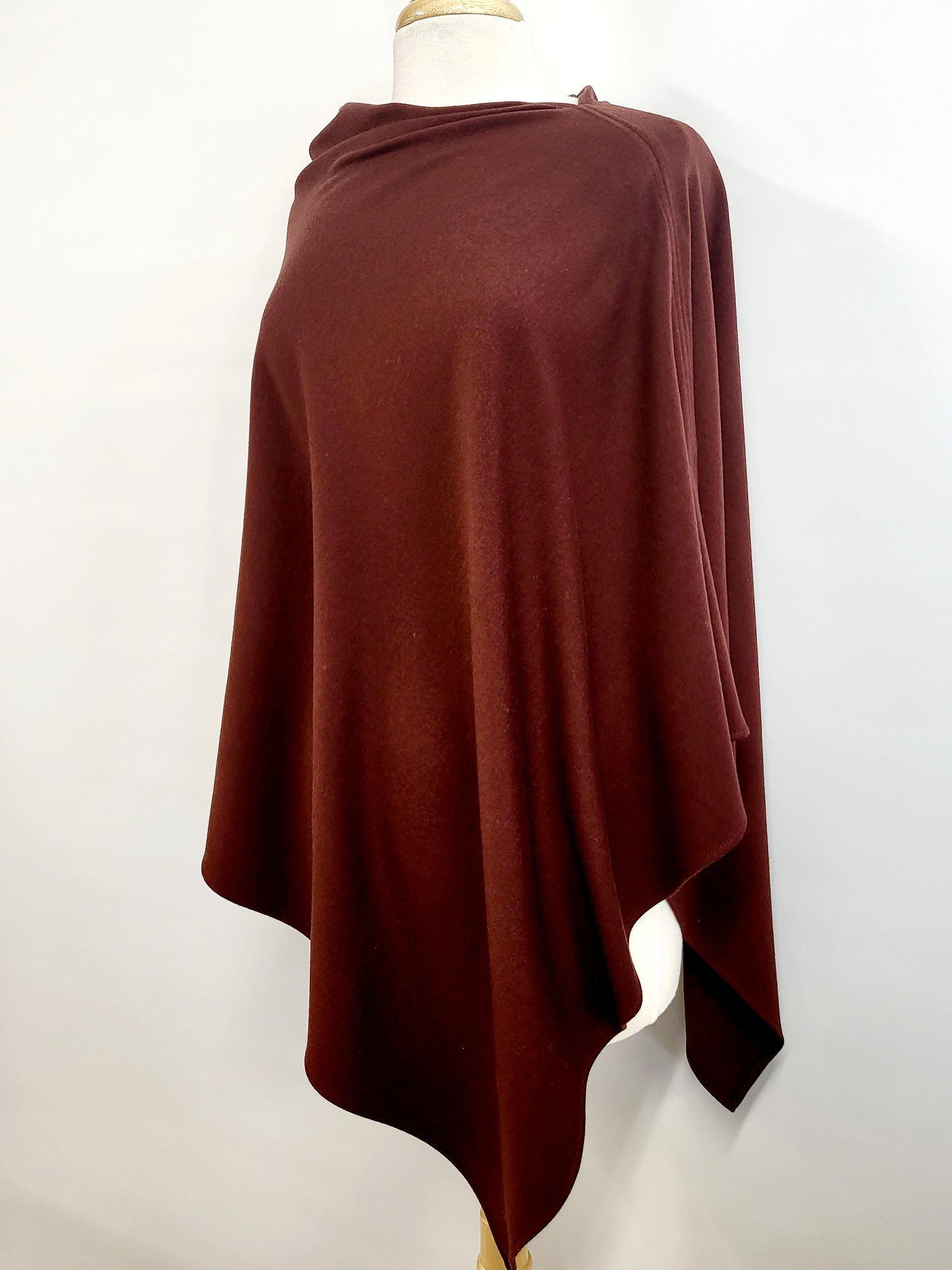 Long asymmetrical poncho in brown-red merino wool knit