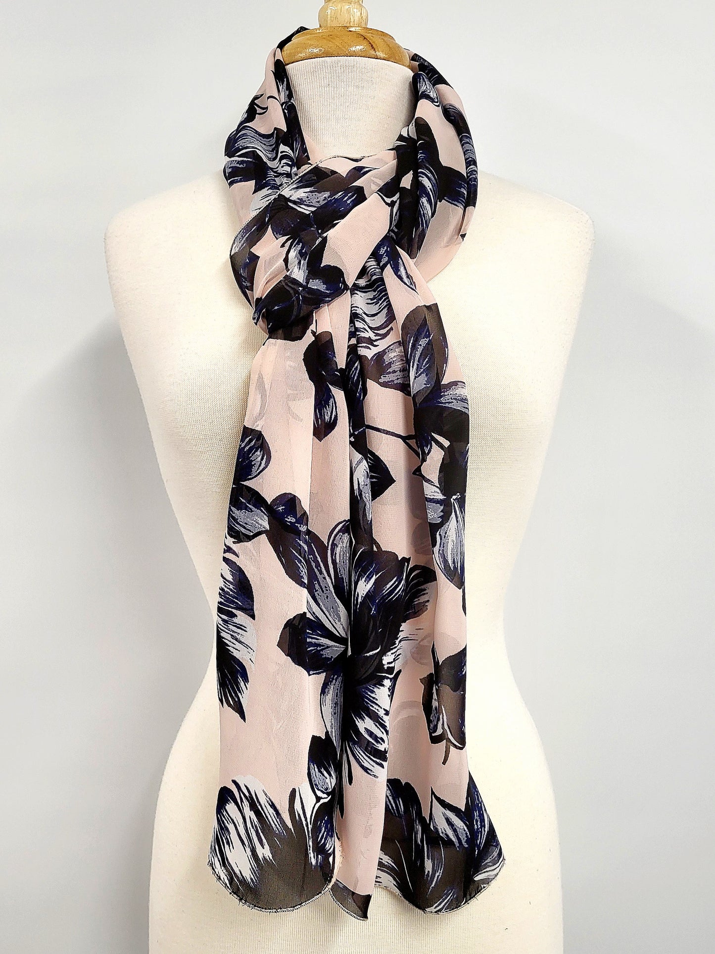 Long voile scarf printed with navy flowers on a pink background