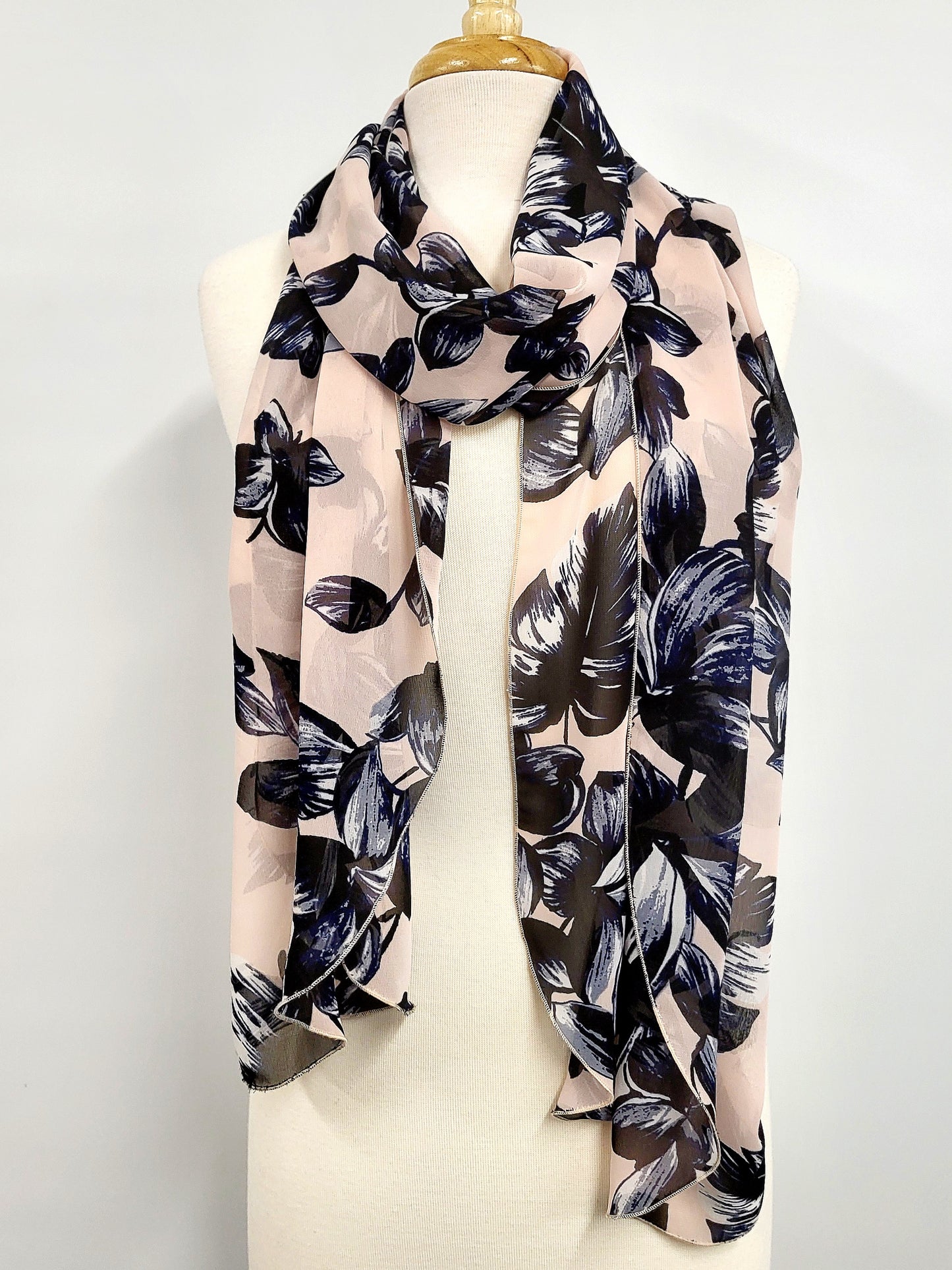 Long voile scarf printed with navy flowers on a pink background