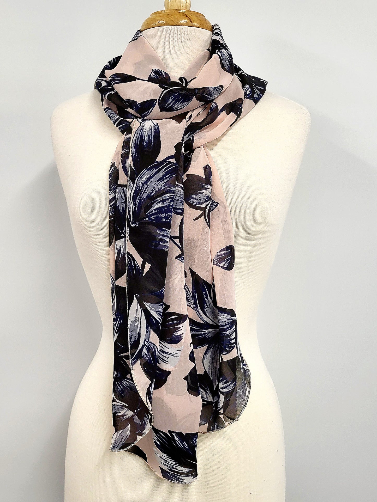 Long voile scarf printed with navy flowers on a pink background