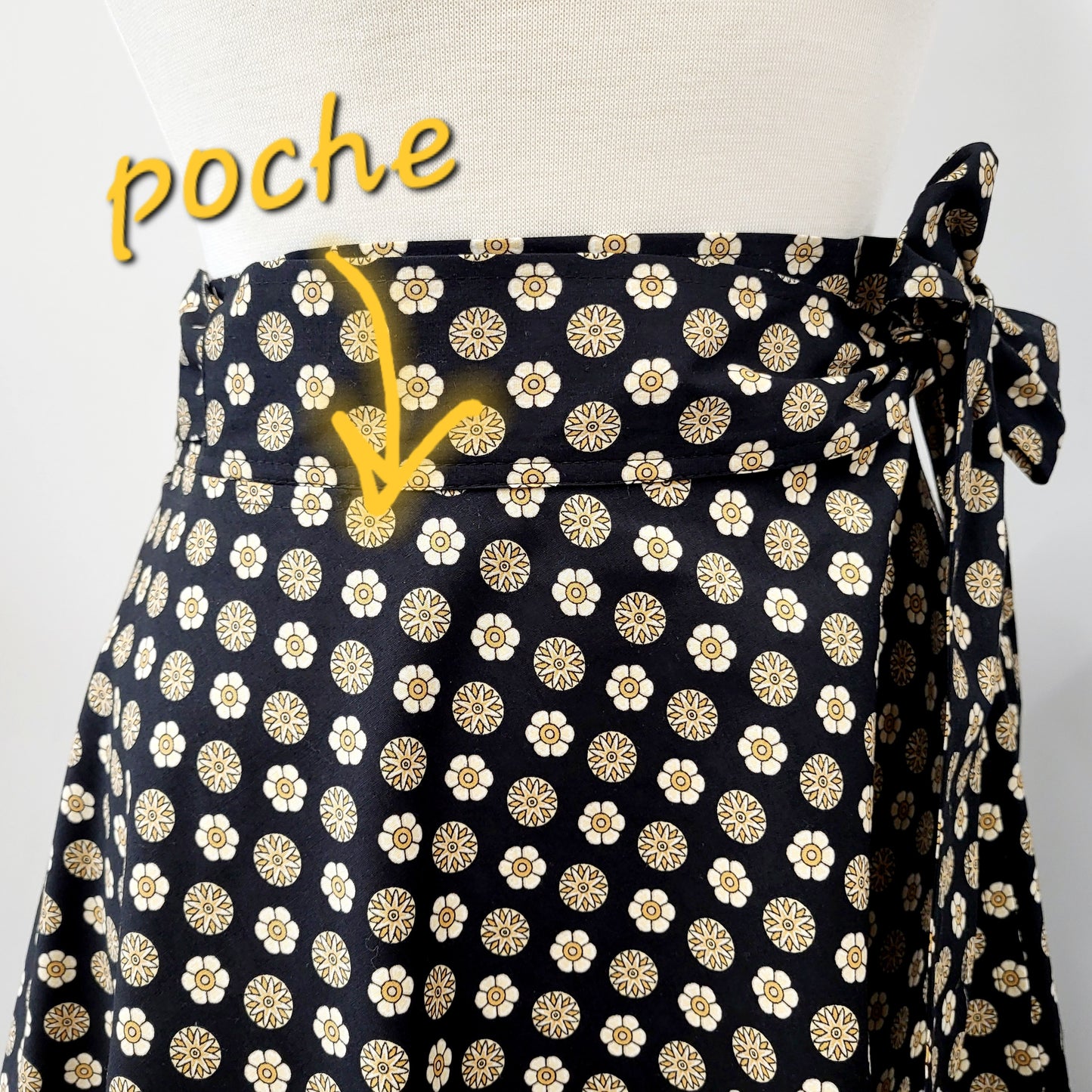 Cotton wrap skirt with small beige and yellow patterns on a black background