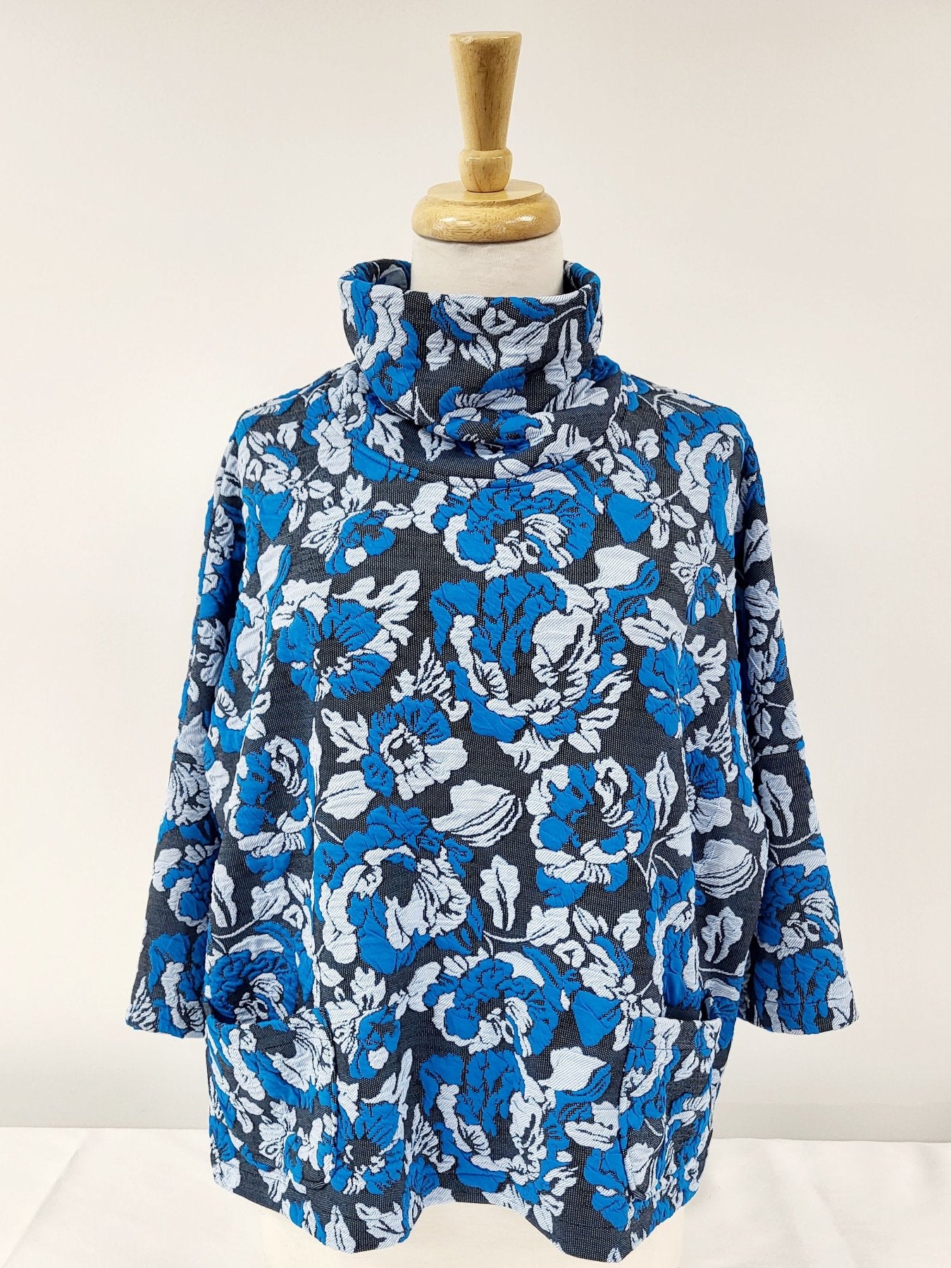 Julie Top - loose-fitting with high neck and pockets in turquoise, gray and black knit.