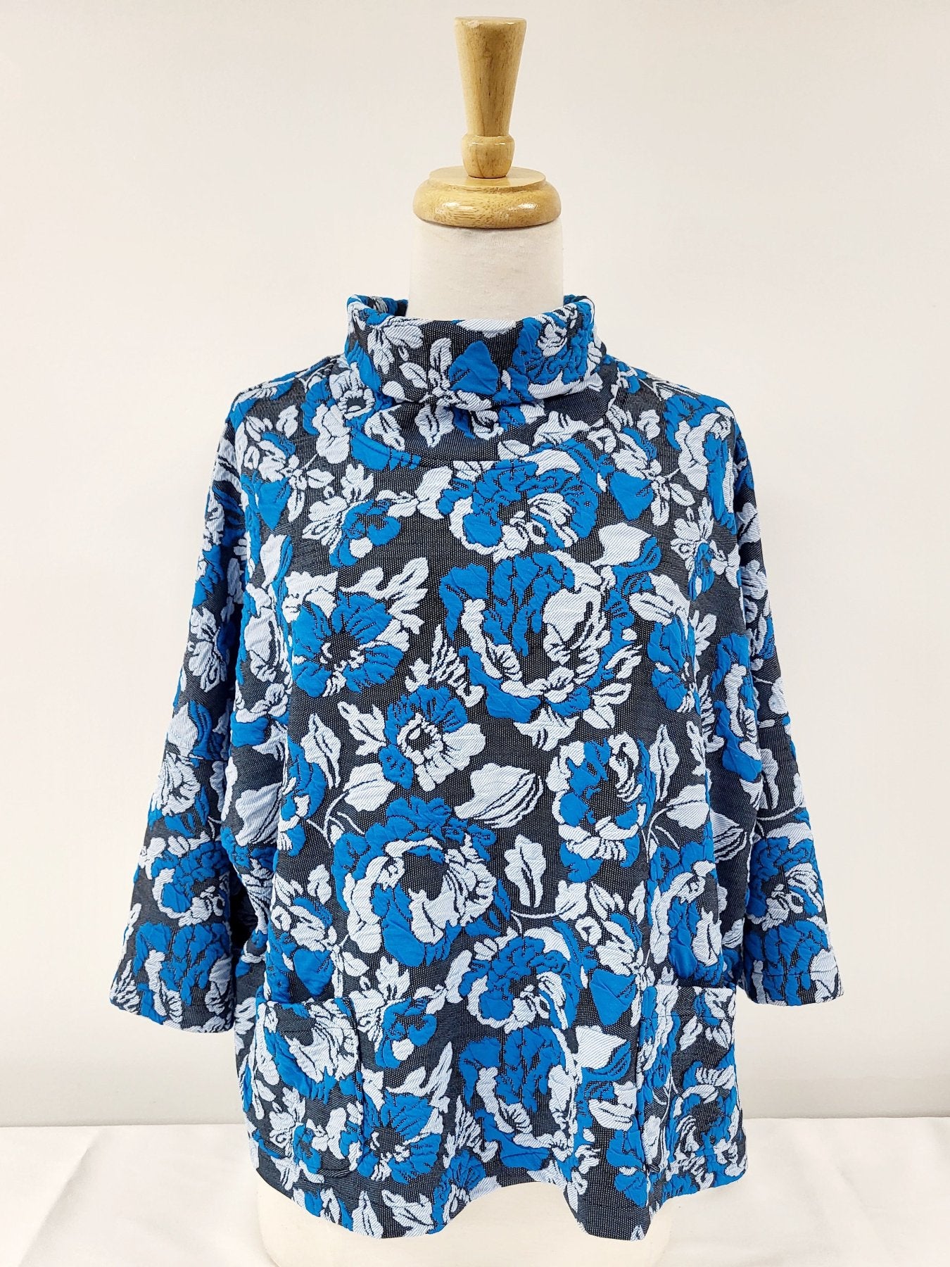 Julie Top - loose-fitting with high neck and pockets in turquoise, gray and black knit.