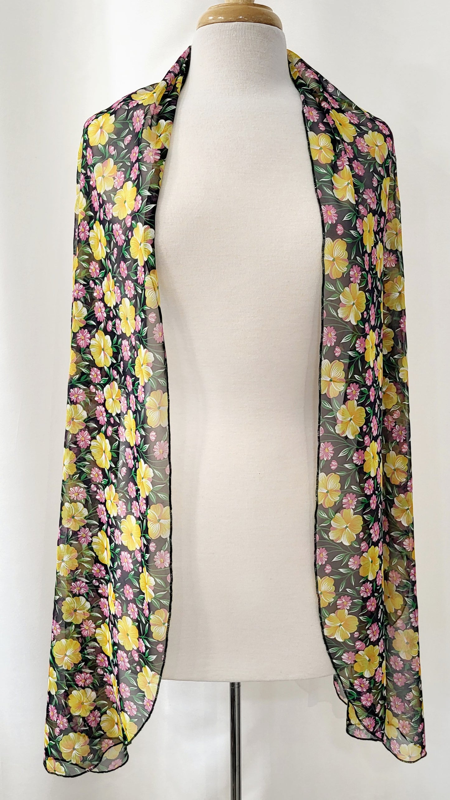 Long voile scarf printed with yellow, pink flowers and green foliage.