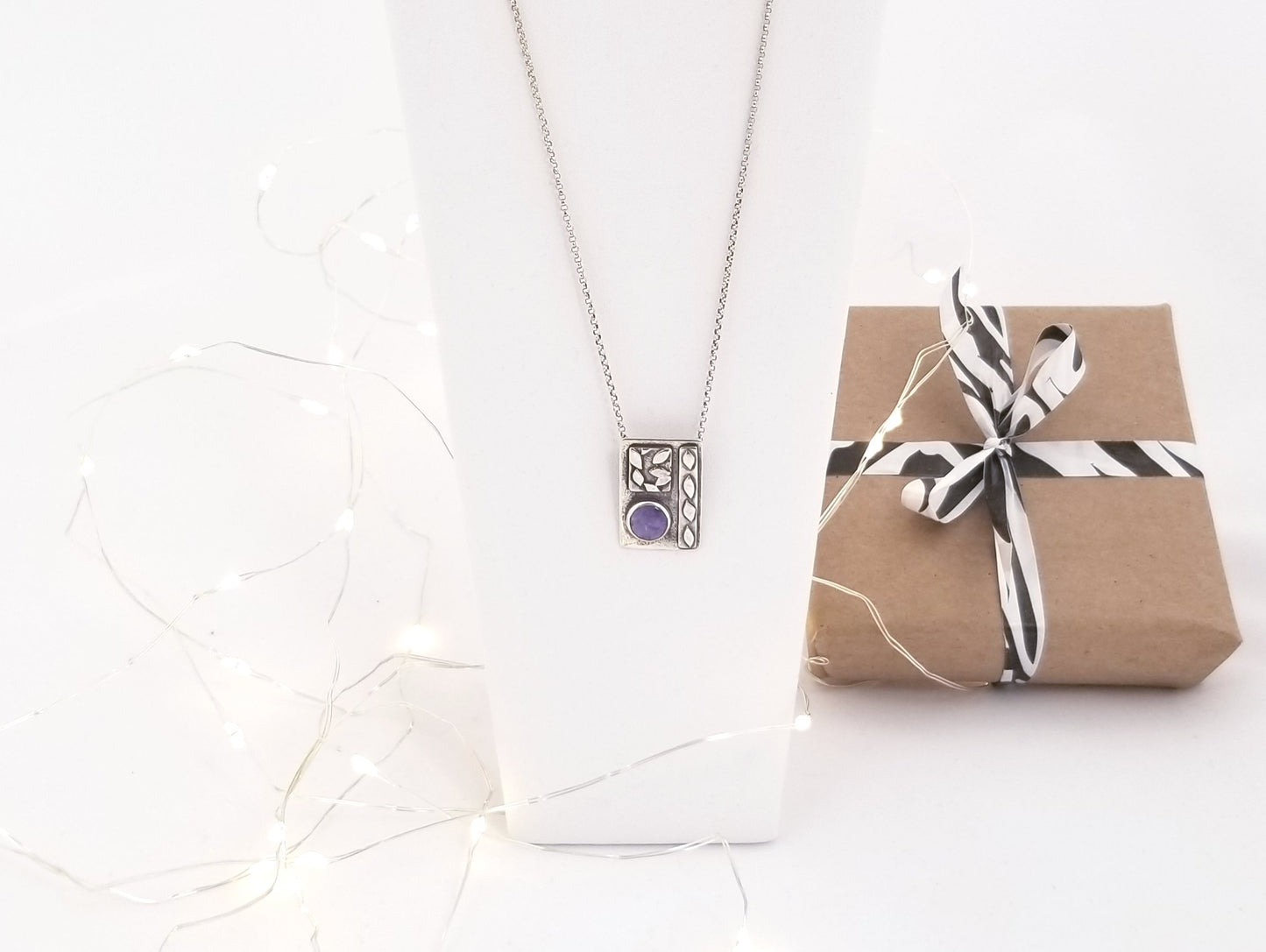 Necklace with small silver leaves and natural purple stone