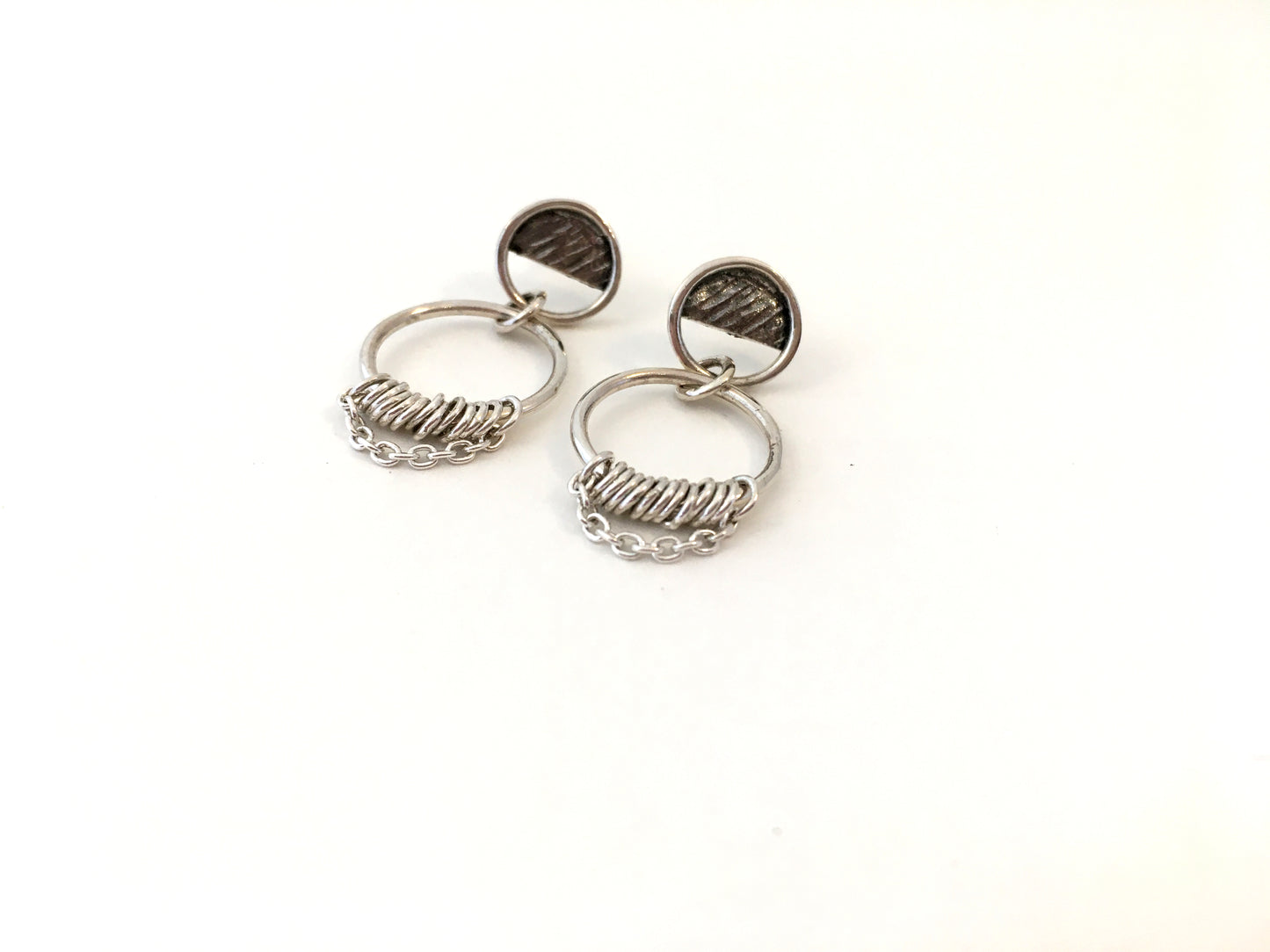 Round silver earrings with dangling ring and chain