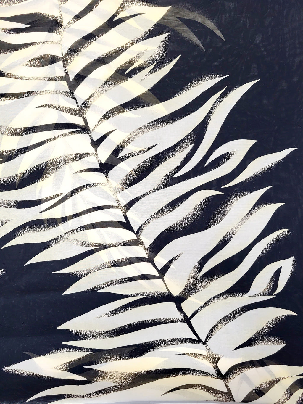 Circular scarf with fern print on a black background