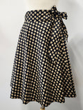 Cotton wrap skirt with small beige and yellow patterns on a black background