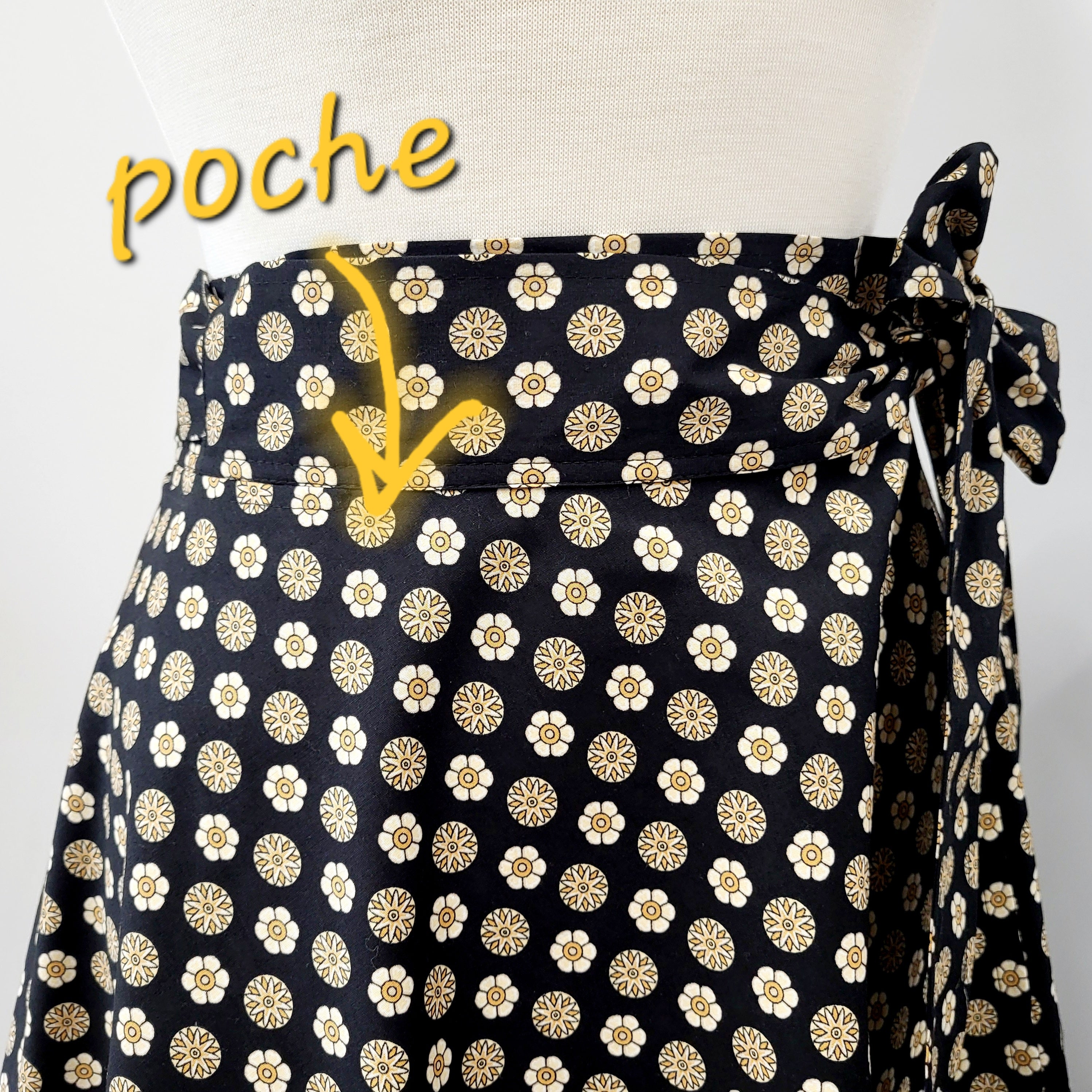 Cotton wrap skirt with small beige and yellow patterns on a black background