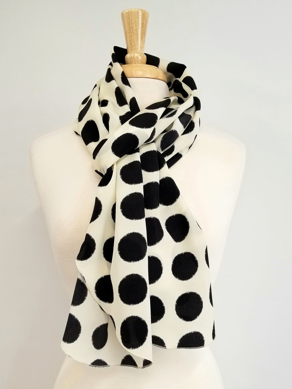 Long silk scarf, black polka dot print on an ecru background.