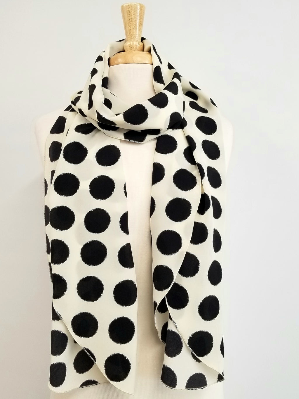 Long silk scarf, black polka dot print on an ecru background.