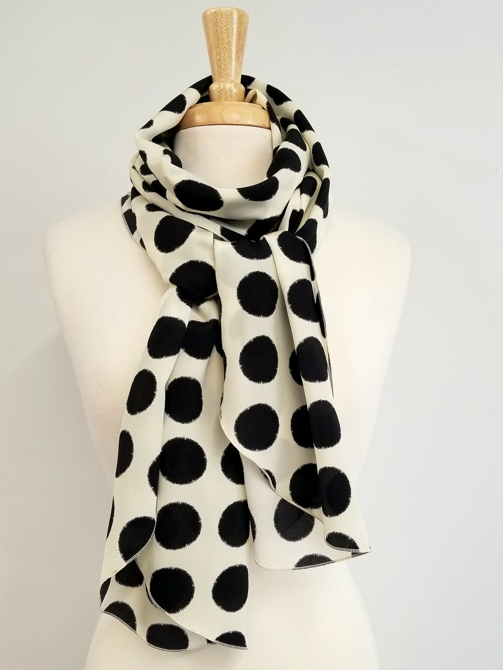 Long silk scarf, black polka dot print on an ecru background.
